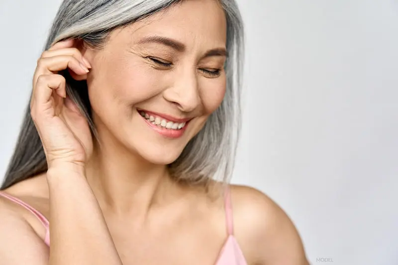 Happy woman after cosmetic surgery.