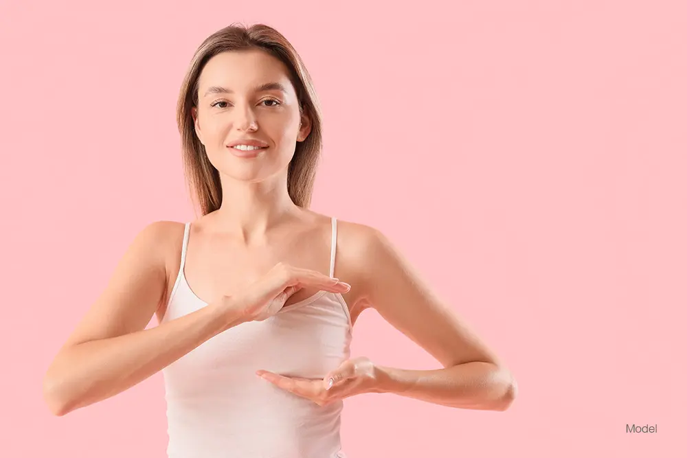 Woman standing in front of a pink background