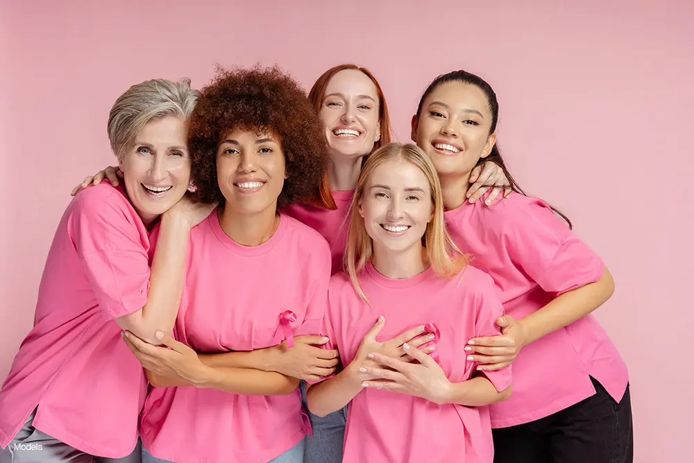 A group of women wearing pink in support of breast cancer awareness