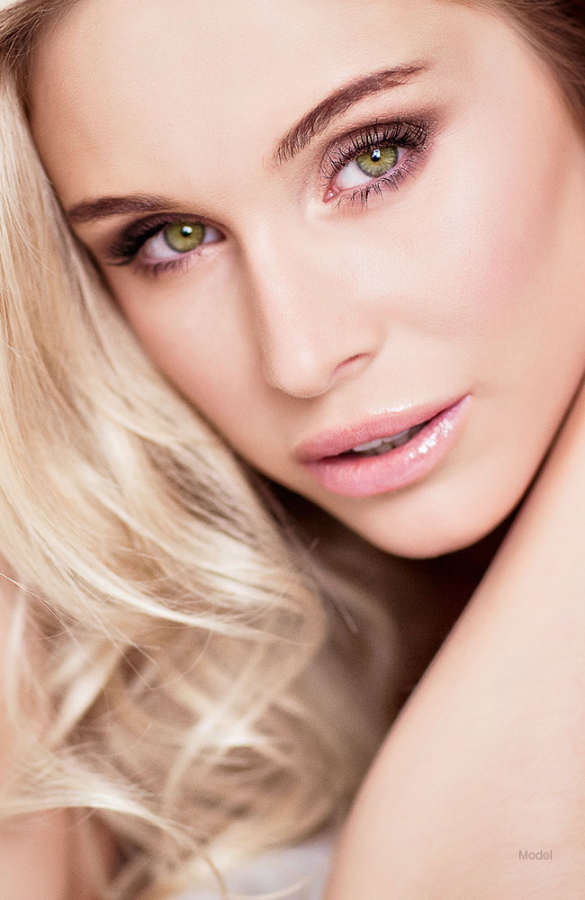 Close up headshot of beautiful blonde woman with a sculpted nose