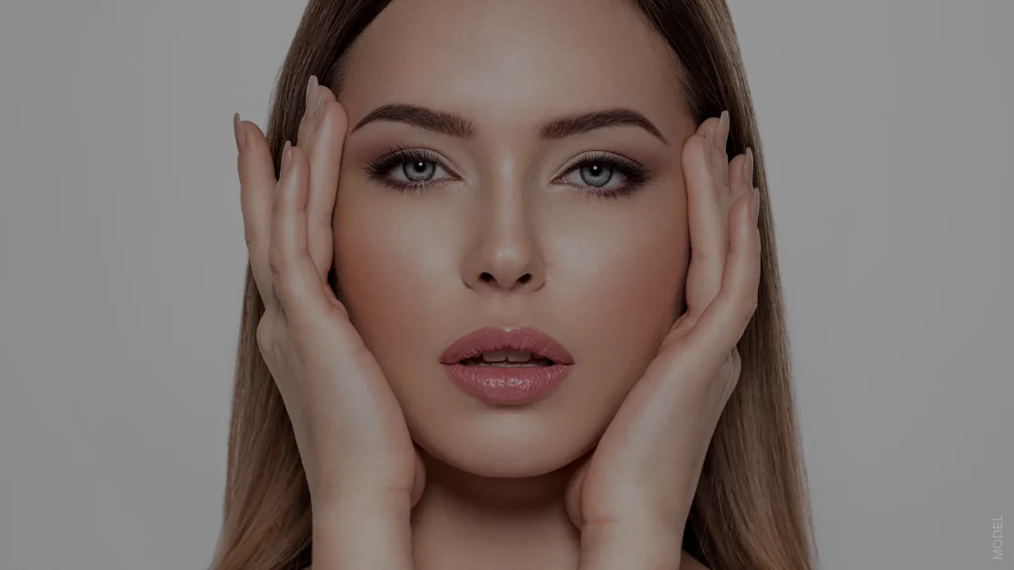 woman touching the side of her face