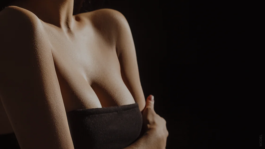 woman against a black background with a black top