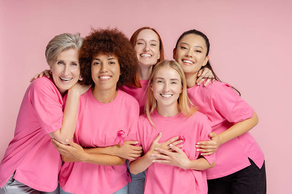A group of women wearing pink in support of breast cancer awareness
