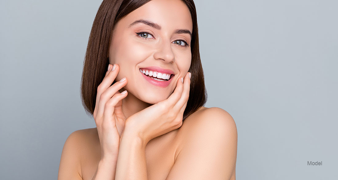 woman touching her face